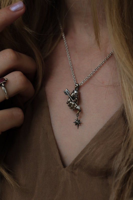 victorian style hand pendant with arrow and star