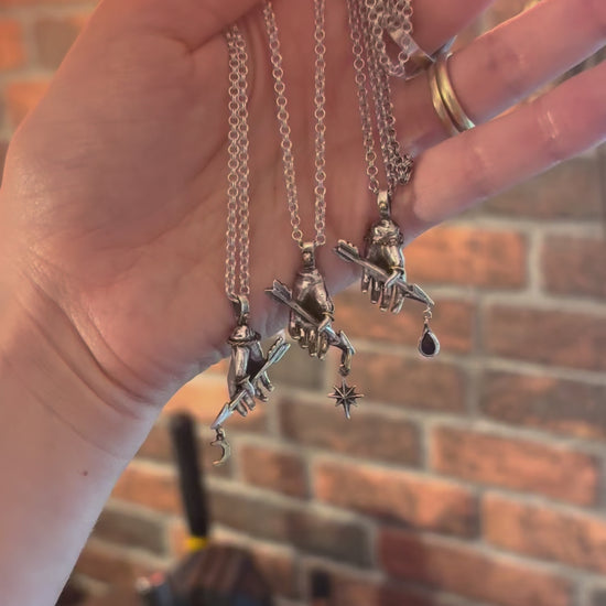 three victorian style hand pendants on silver chains
