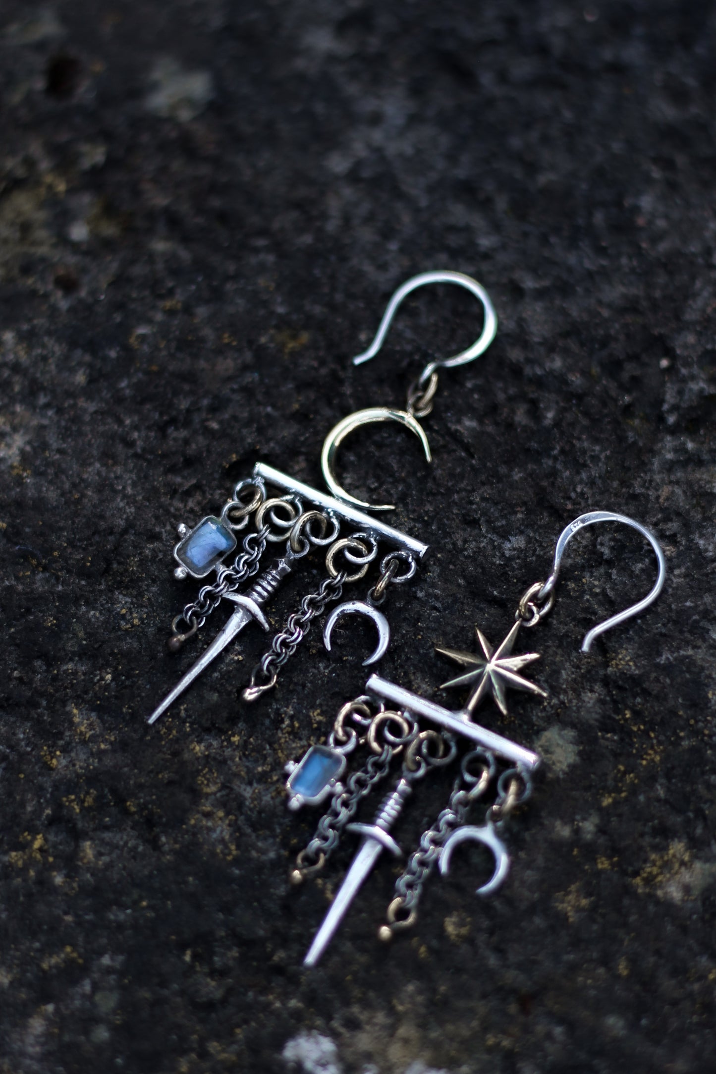 velar celestial moon and star swords earrings flat lay picture