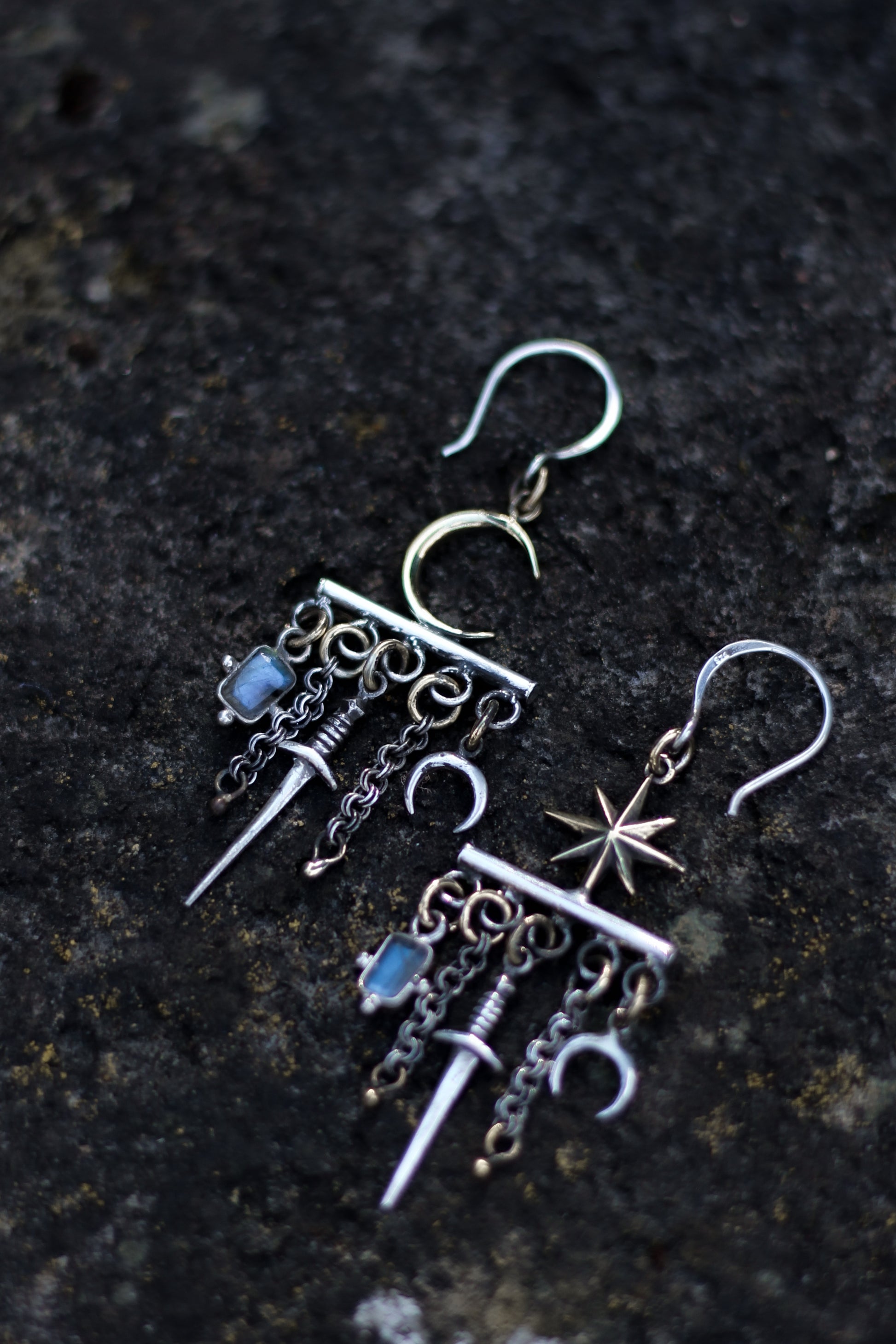 velar celestial moon and star swords earrings flat lay picture